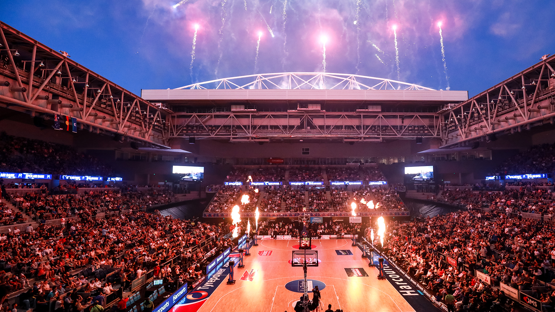 A packed crowd enjoying a basketball game at John Cain Arena.