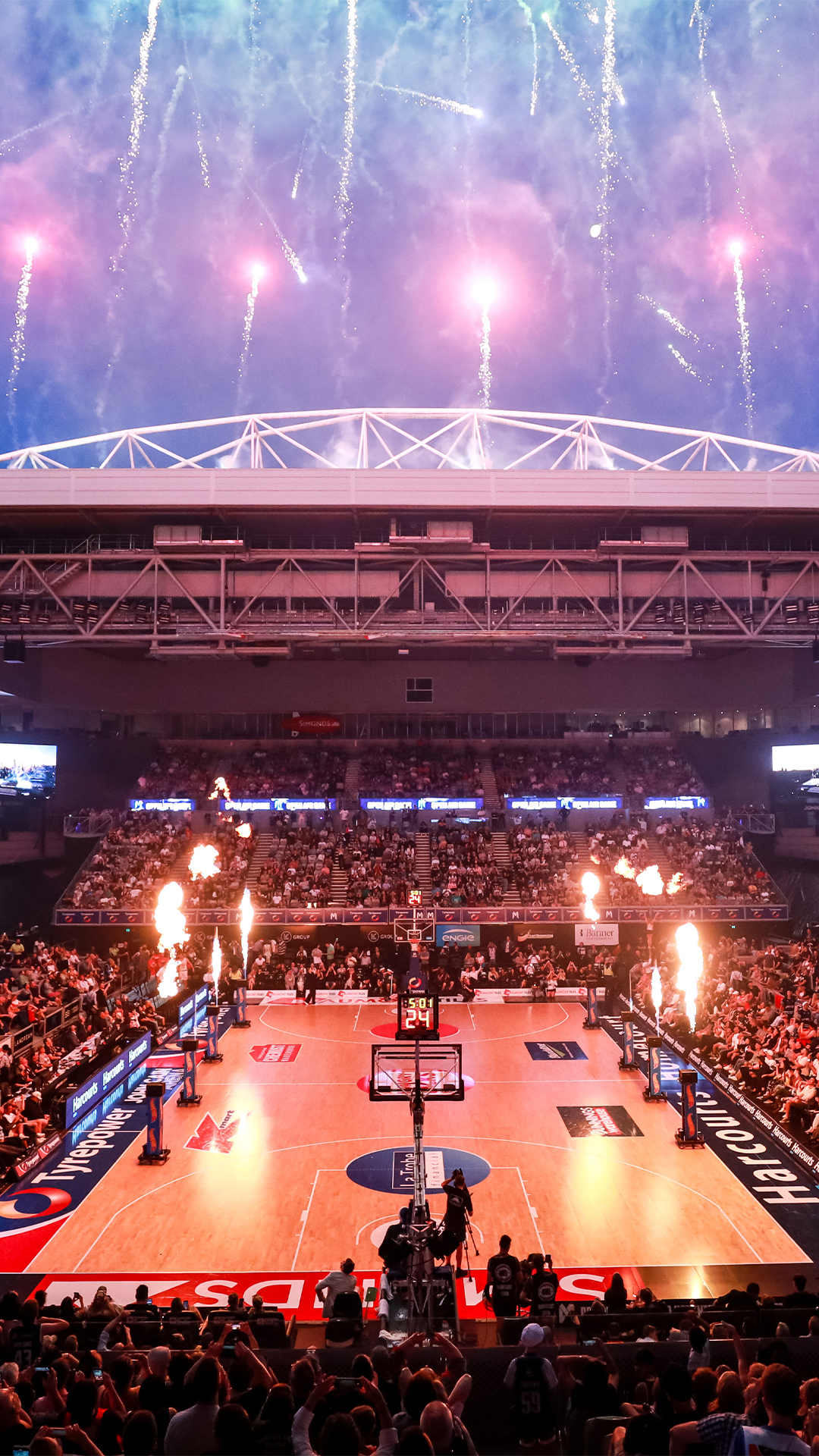 A packed crowd enjoying a basketball game at John Cain Arena.