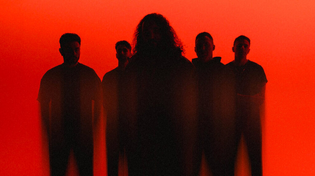 Five band members in shadows in front of a red background.