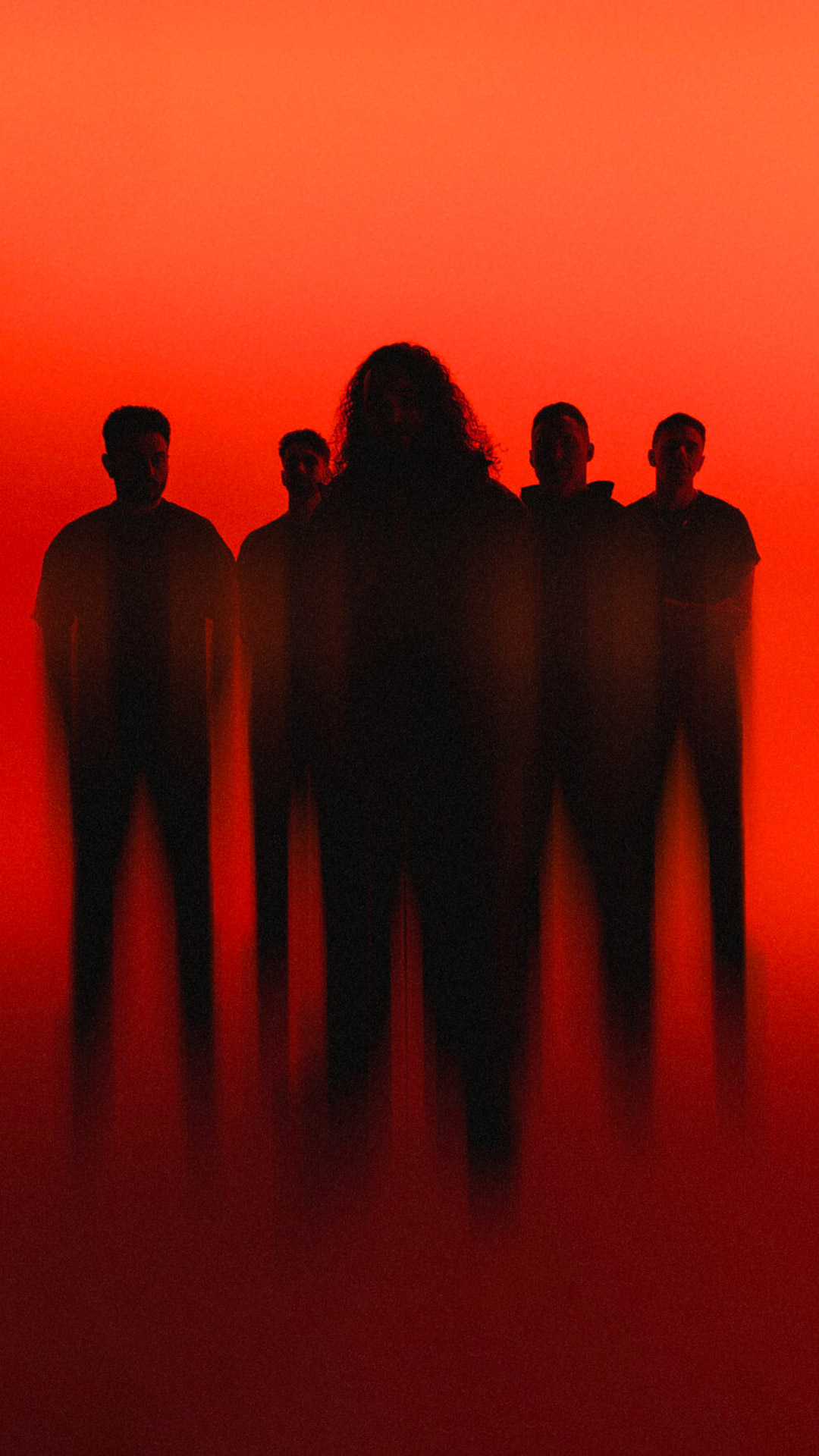 Five band members in shadows in front of a red background.