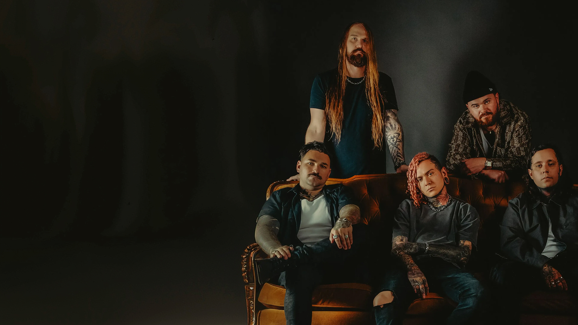 Lorna Shore band members band pose together in front of a solid black background.