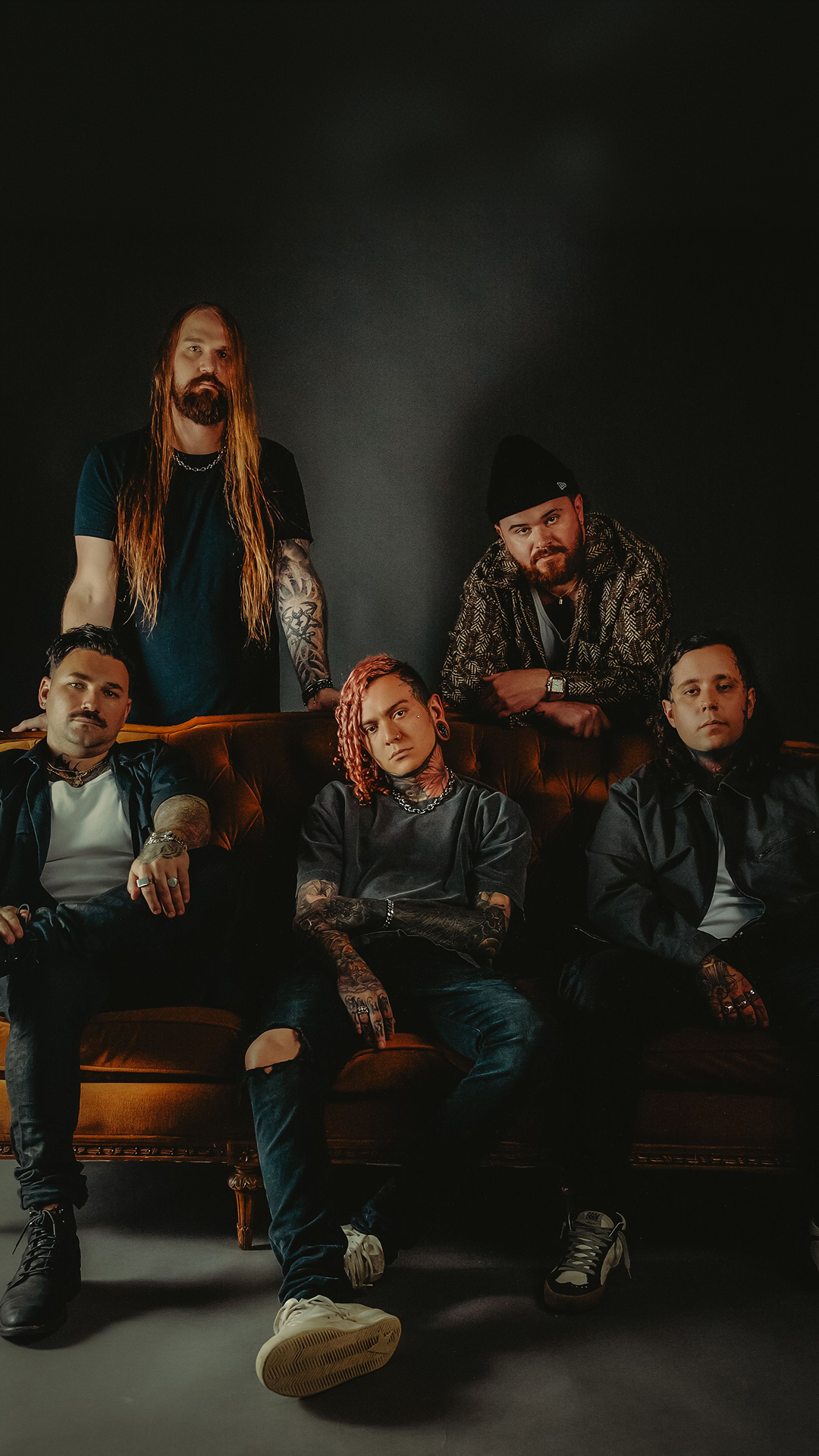Lorna Shore band members band pose together in front of a solid black background.